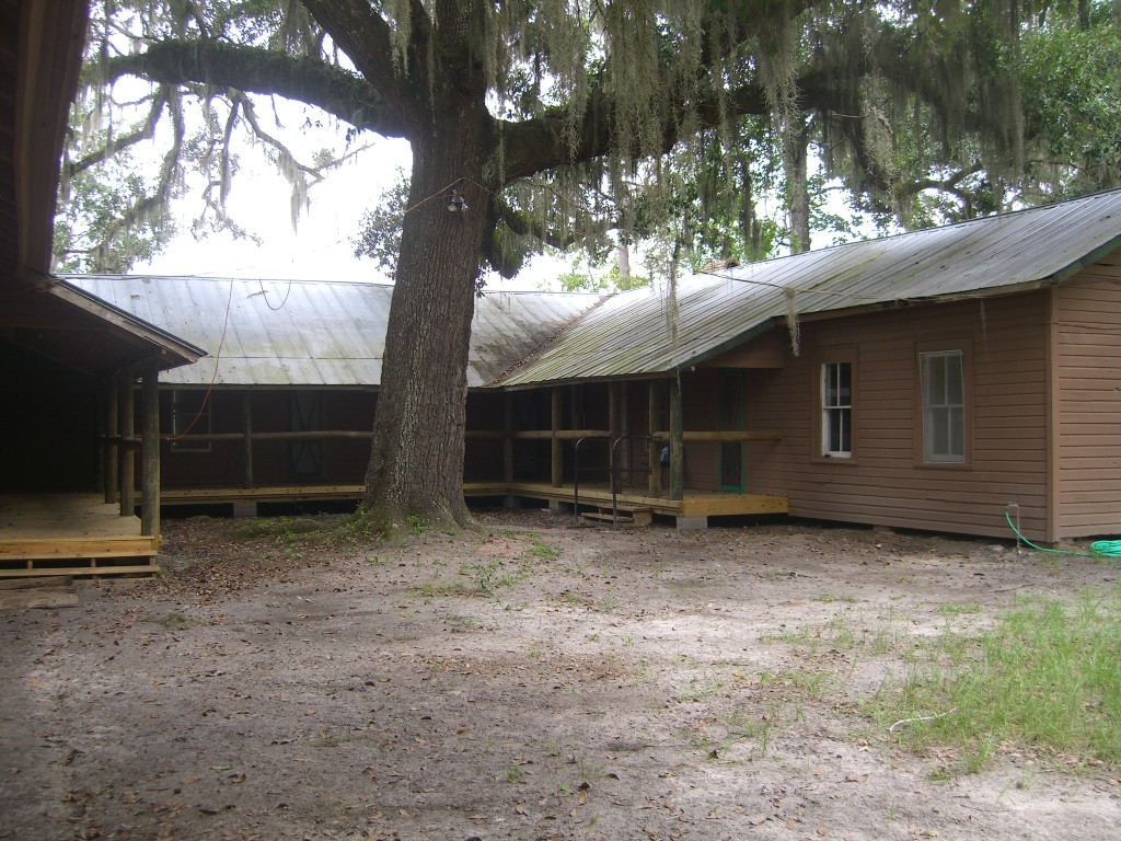 Lodge driveway entrance with moss draped Live Oak